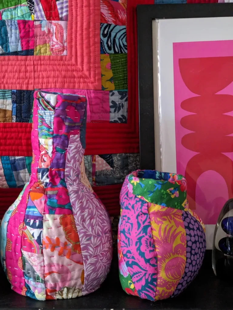 Close up of two fiber art vessels by Kate Sandford