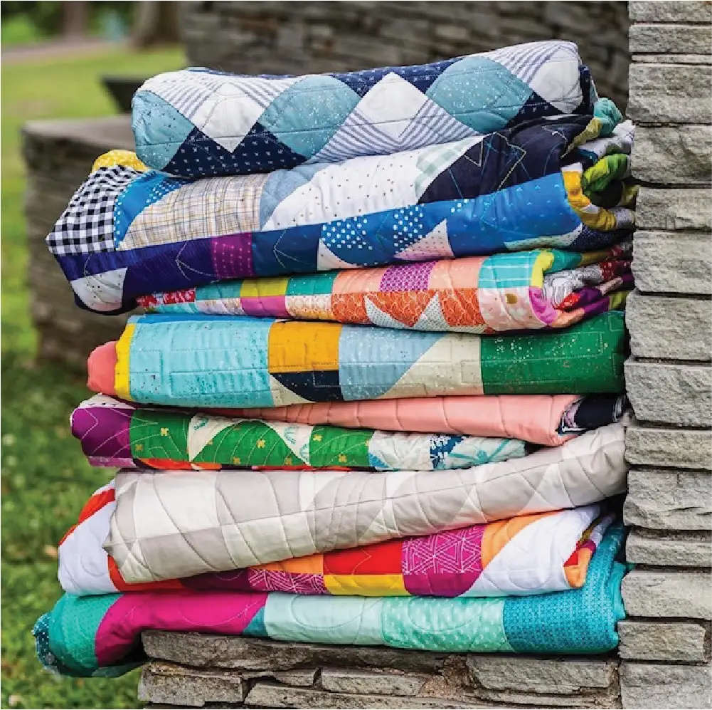 Stack of quilts quilted by Lilo Whitener-Fey