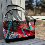 Finished bag with rivet leather handles