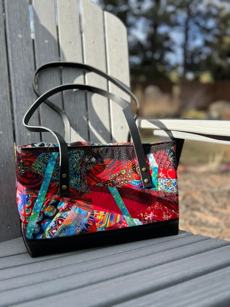 Finished bag with rivet leather handles