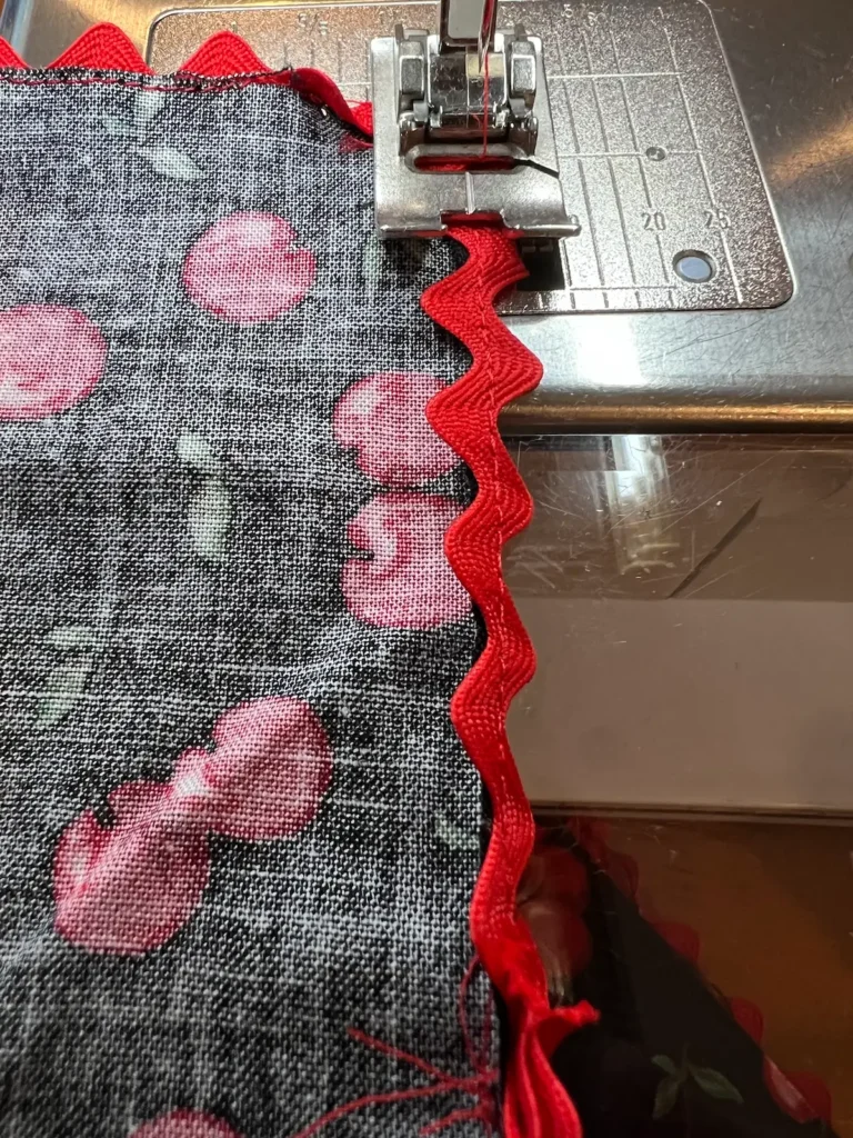 Turn the rick rack to the back of the napkin and stitch in place