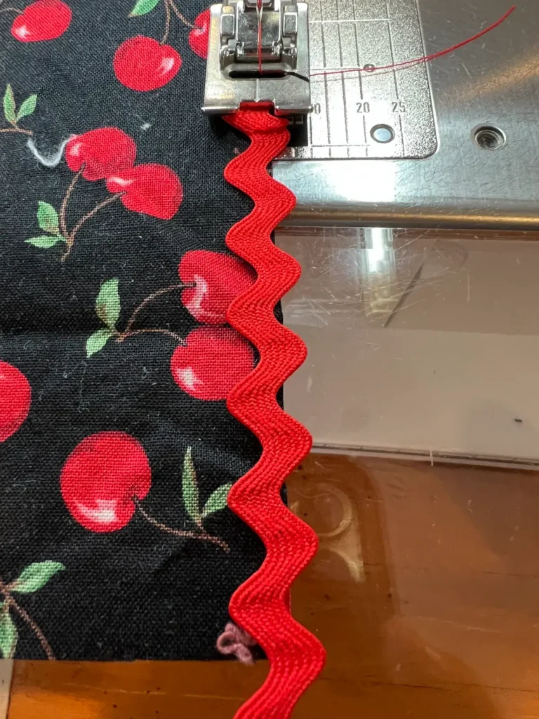 Stitch the rick rack on the napkin along the edge.