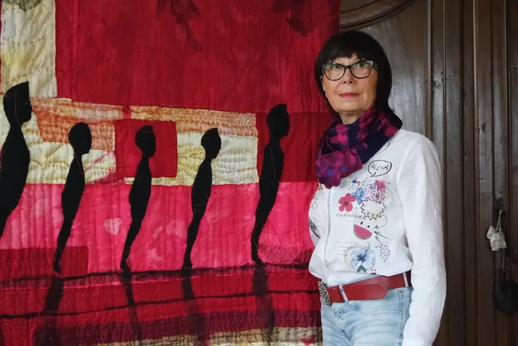 Tiziana Tateo next to one of her fiber art pieces