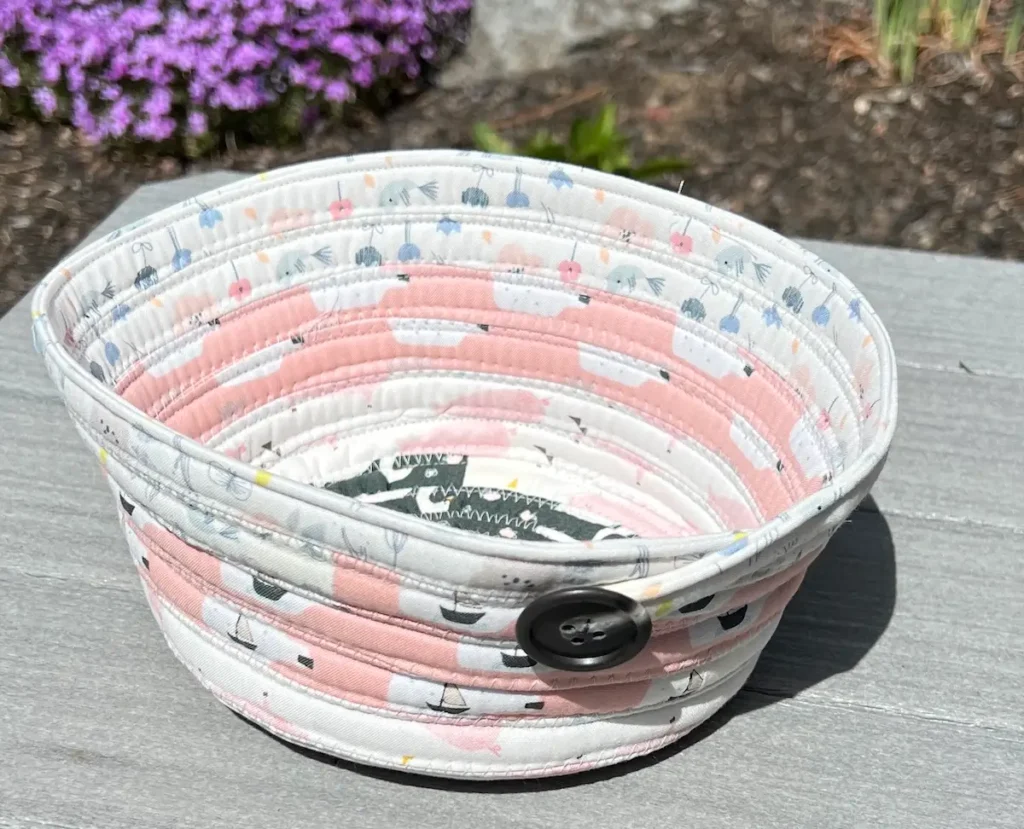 Fabric tube basket finished with a button