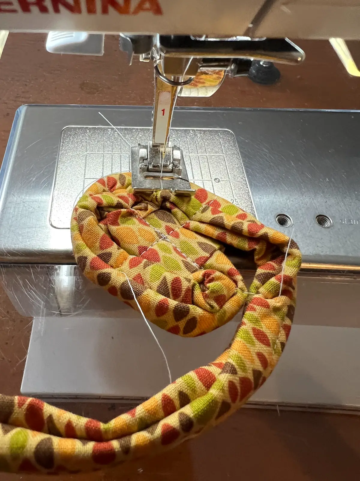 Fabric tube with tool sewing the start like a spider web