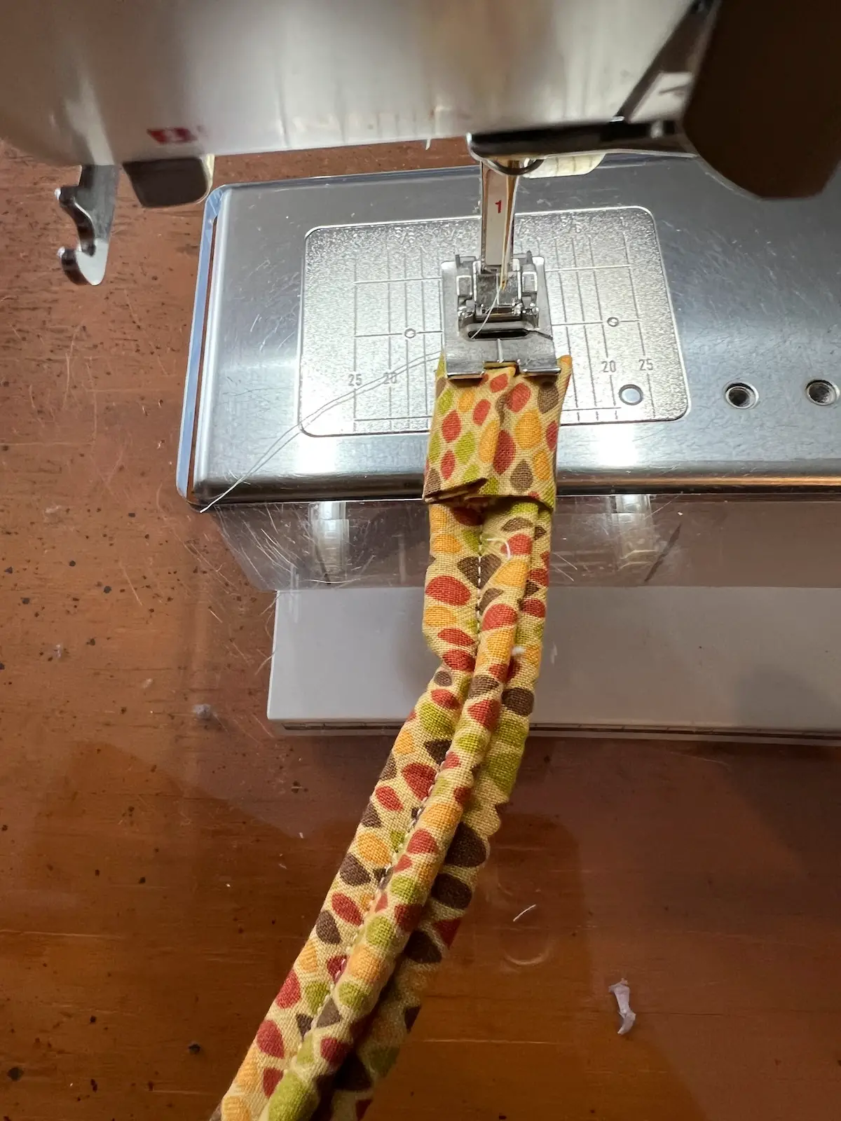Fabric tube with tool showing how to add fabric to finish the ends