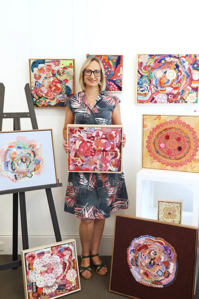 Elizabeth Sullivan with 8 of her artworks