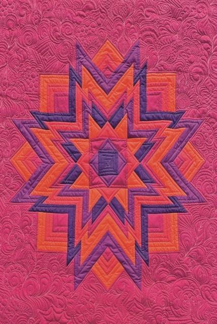Pink, orange, red and purple quilt stitched by Karlee Porter