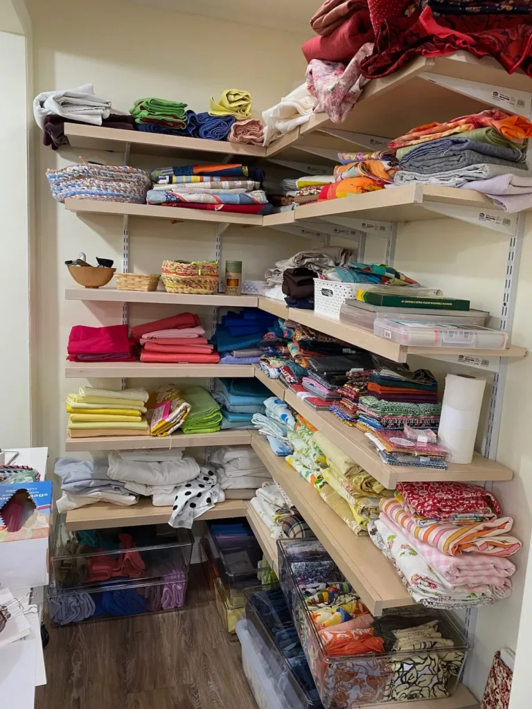 Lela O'Dells studio showing fabric on shelves