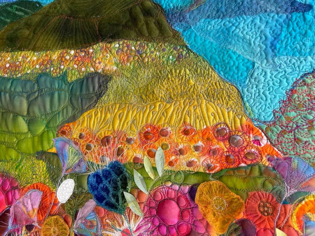 Art quilt by Michelle Mischkulnig with mountains and flowers