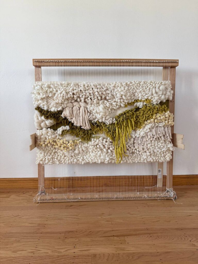 Beige and green weaving by Adriene Busch