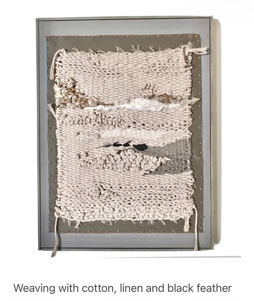 Weaving with cotton, linen and black feather by Grace Cormier