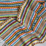 Multi-color crochet shawl showing a variety of stitches by Kate Veselunka