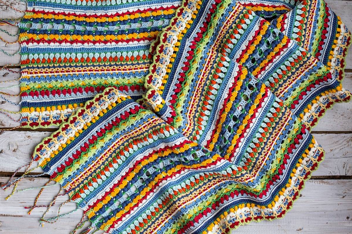 Multi-color crochet shawl showing a variety of stitches by Kate Veselunka