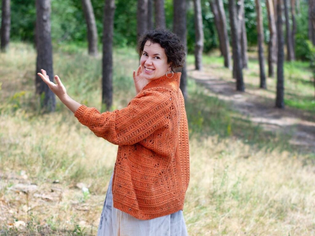 Kate Veselunka in an orange crocheted sweater