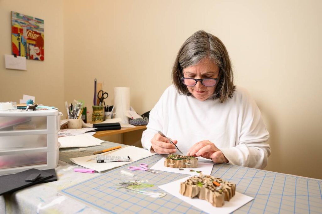 Kim Briet at work on her paper sculptures