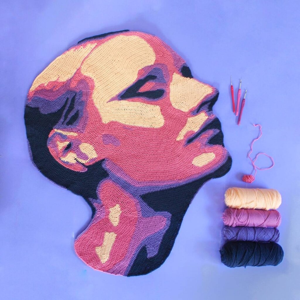 Face crocheted in peach and purple tones by Will Chatlosh
