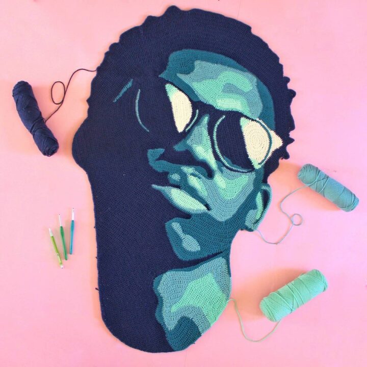 Black man with sunglasses crocheted in tones of blues by Will Chatlosh