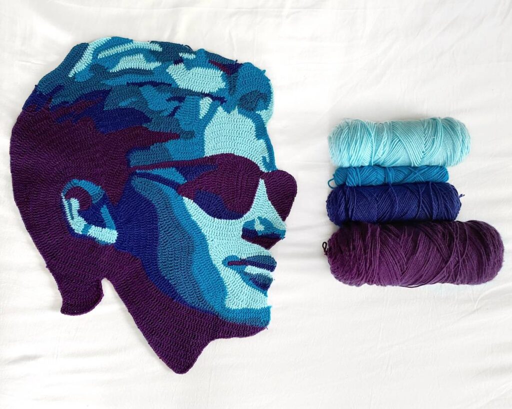 Man with sunglasses crocheted in blues and purple by Will Chatlosh