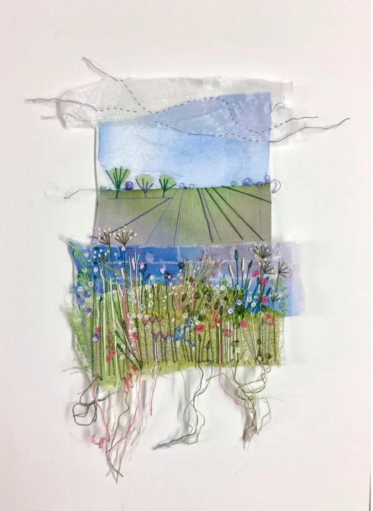 Dot Ronaldson landscape collage with embroidery showing a field of flowers