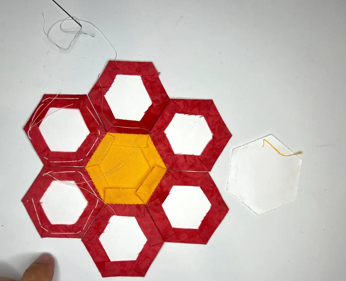 Hexie flower pincushion showing the back take out the center paper before next step