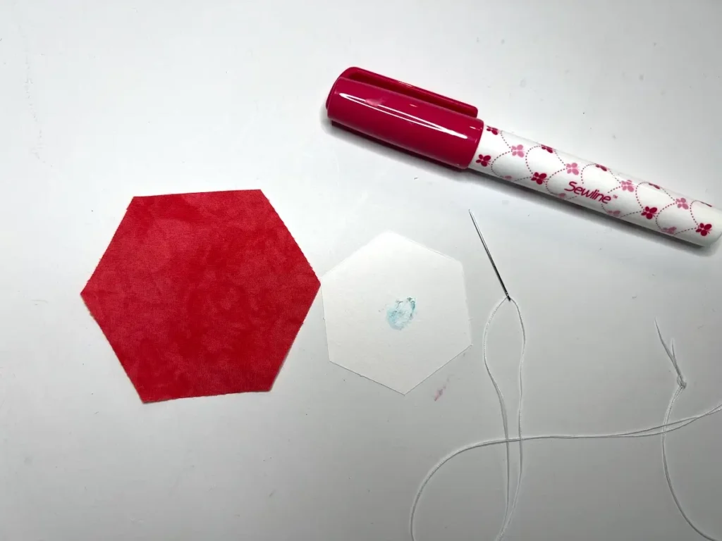 Thread basting dab a little glue on the paper