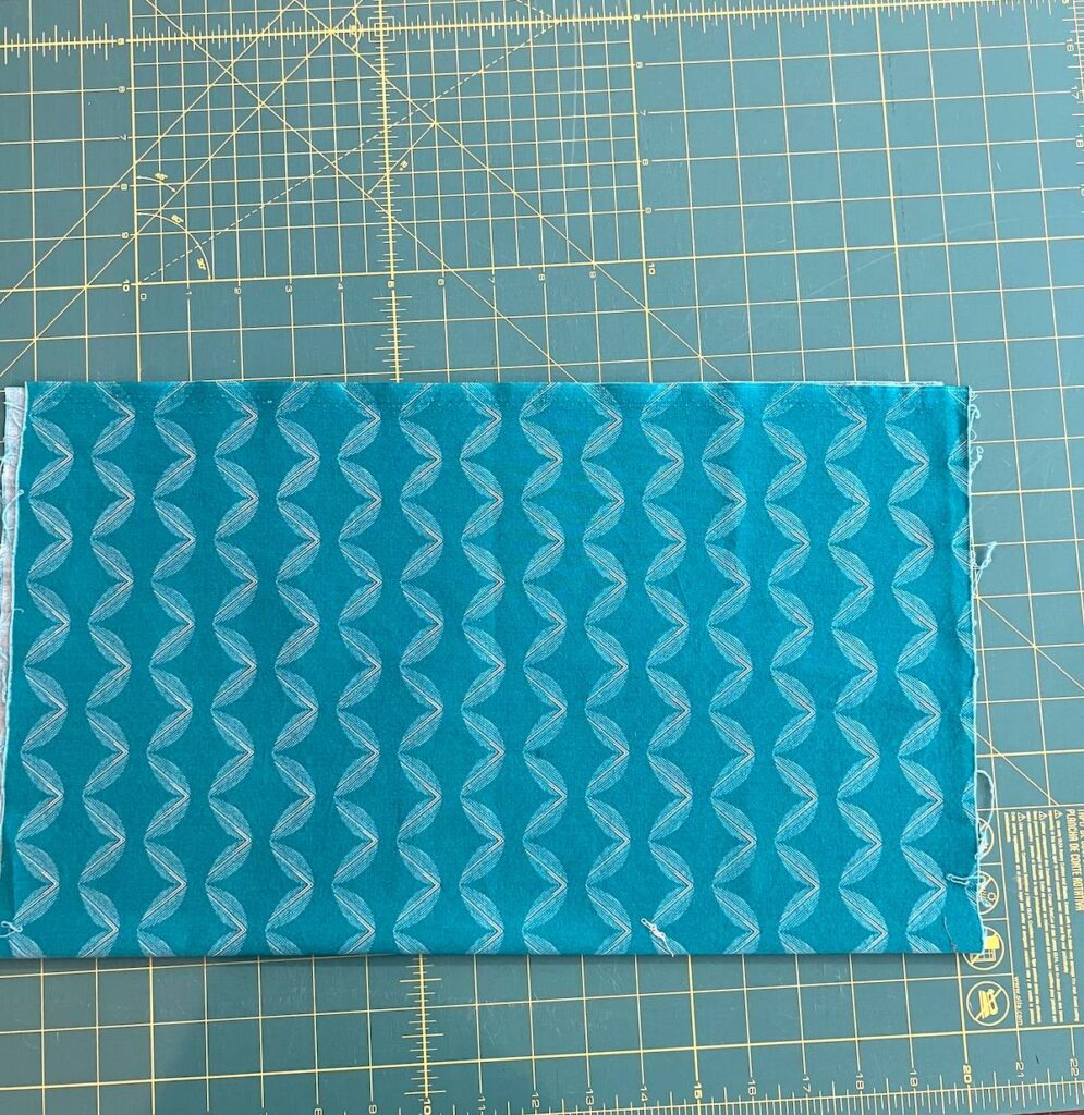Fabric folding for storage showing the first fold