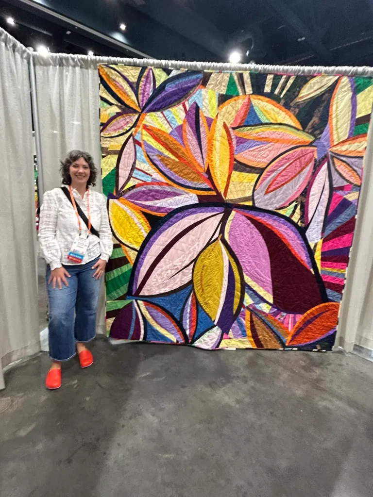 Amanda Milz with one of her quilts at Quiltcon