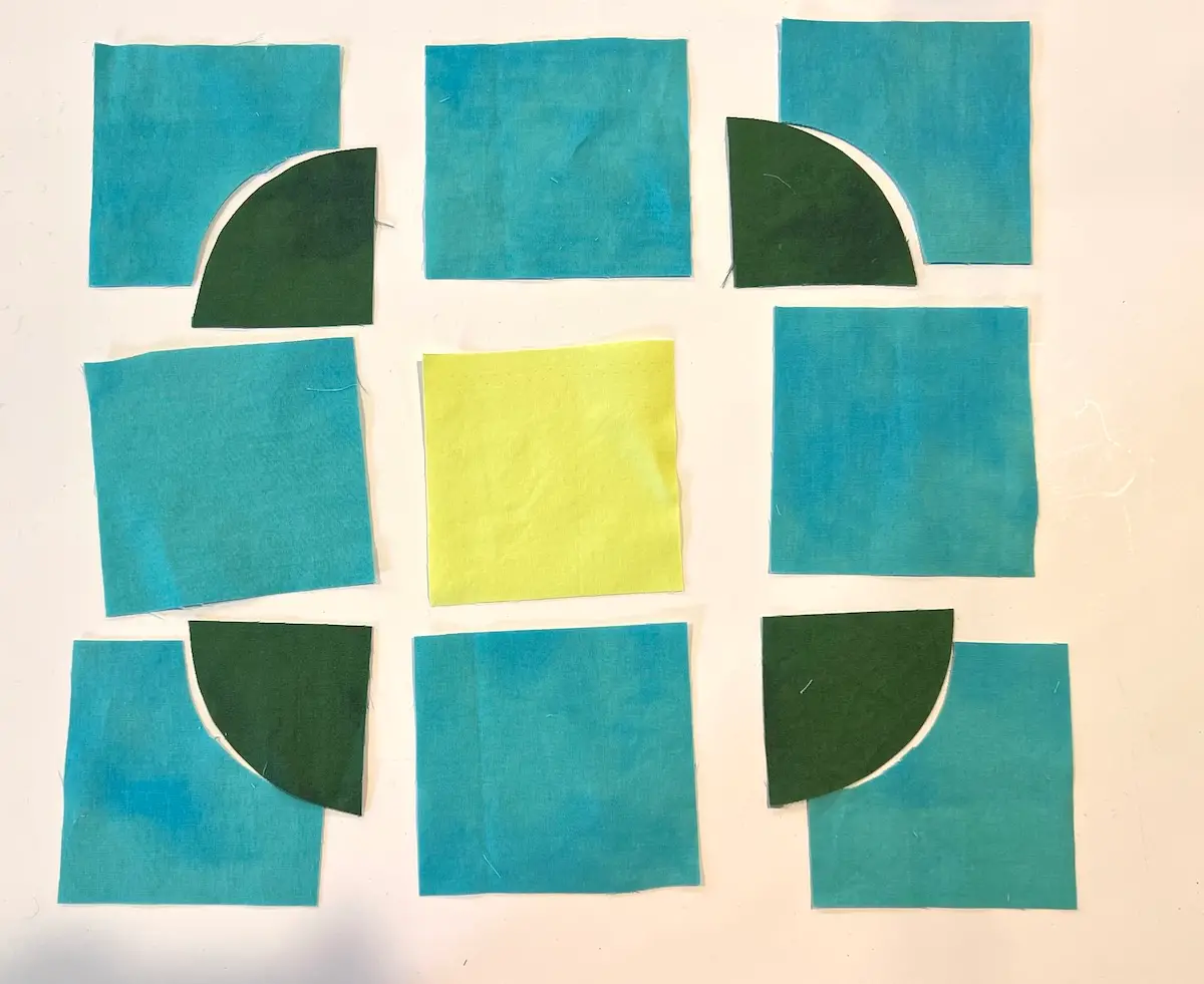 Pieces cut out for the button quilt block