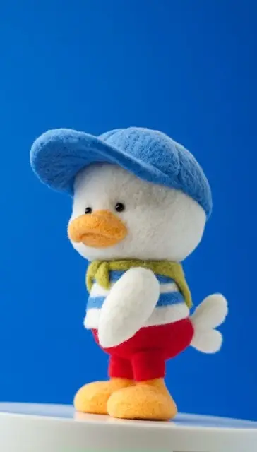 Duck in a baseball cap needle felted by Chelsea Trousdale