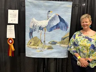 Deborah Csongradi with her award winning crane quilt