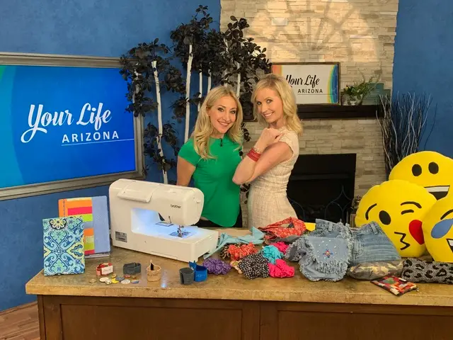 Jane Claus with a TV host doing a segment with a sewing machine