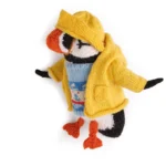 Knitted penguin with sweater, rain slicker and hat by Karla Courtney