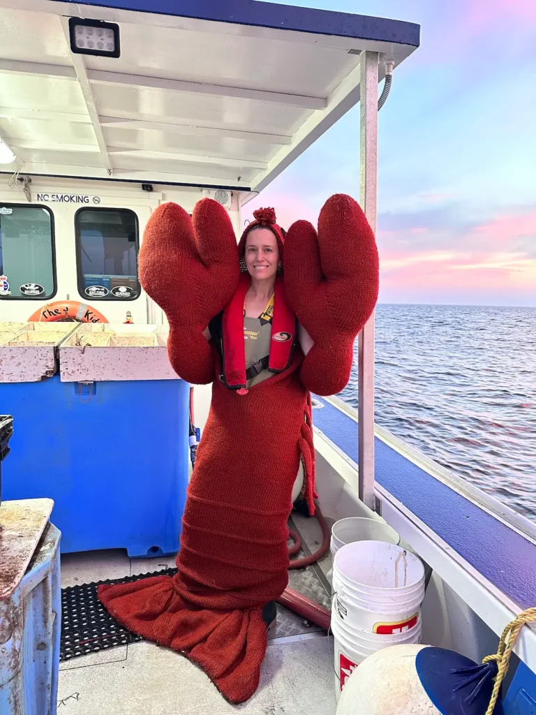 Karla Courtney in a full size knitted crab costume on a boat