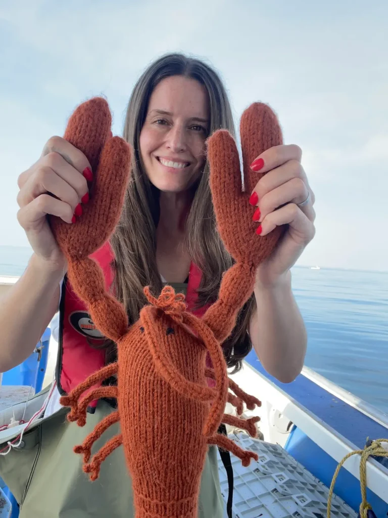 Karla Courtney holding a knitted lobster