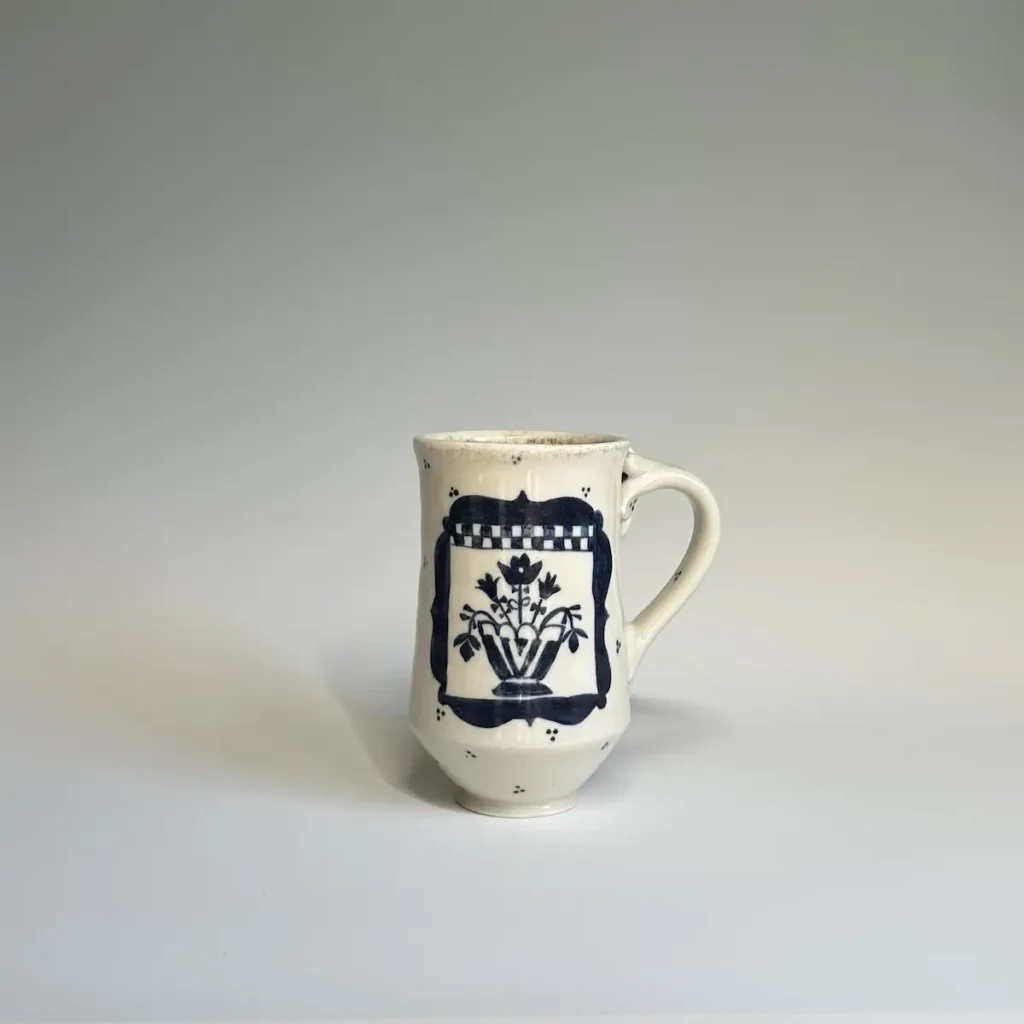 Pottery mug made by Summer Brendlinger with a bouquet of flowers on the front