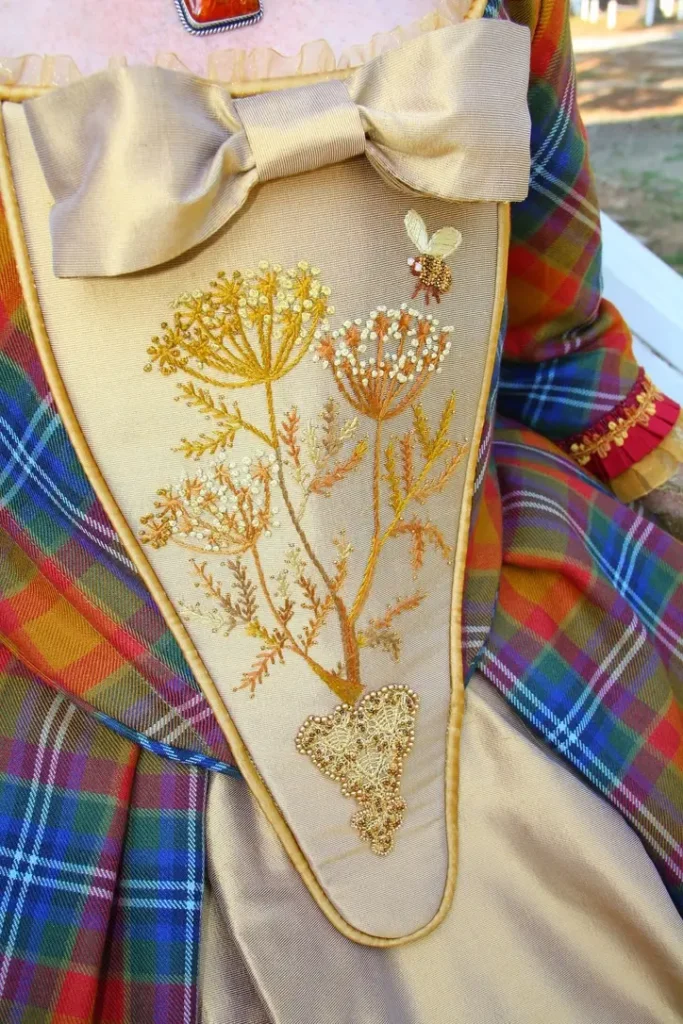 Details of bodice embroidery with flowers and a bee by Teri Biglands
