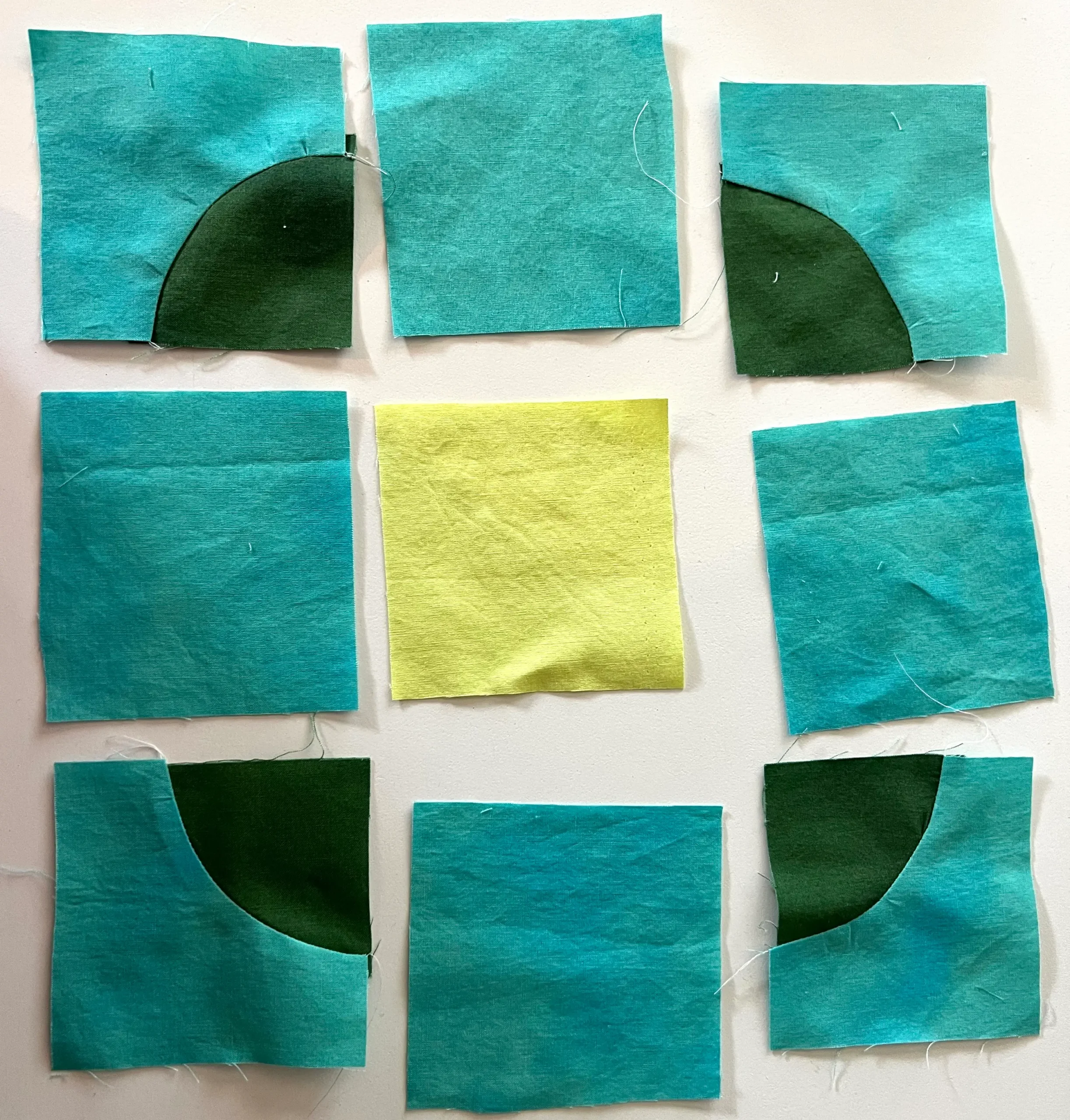 all nine squares ready to be sewn together for the button quilt block