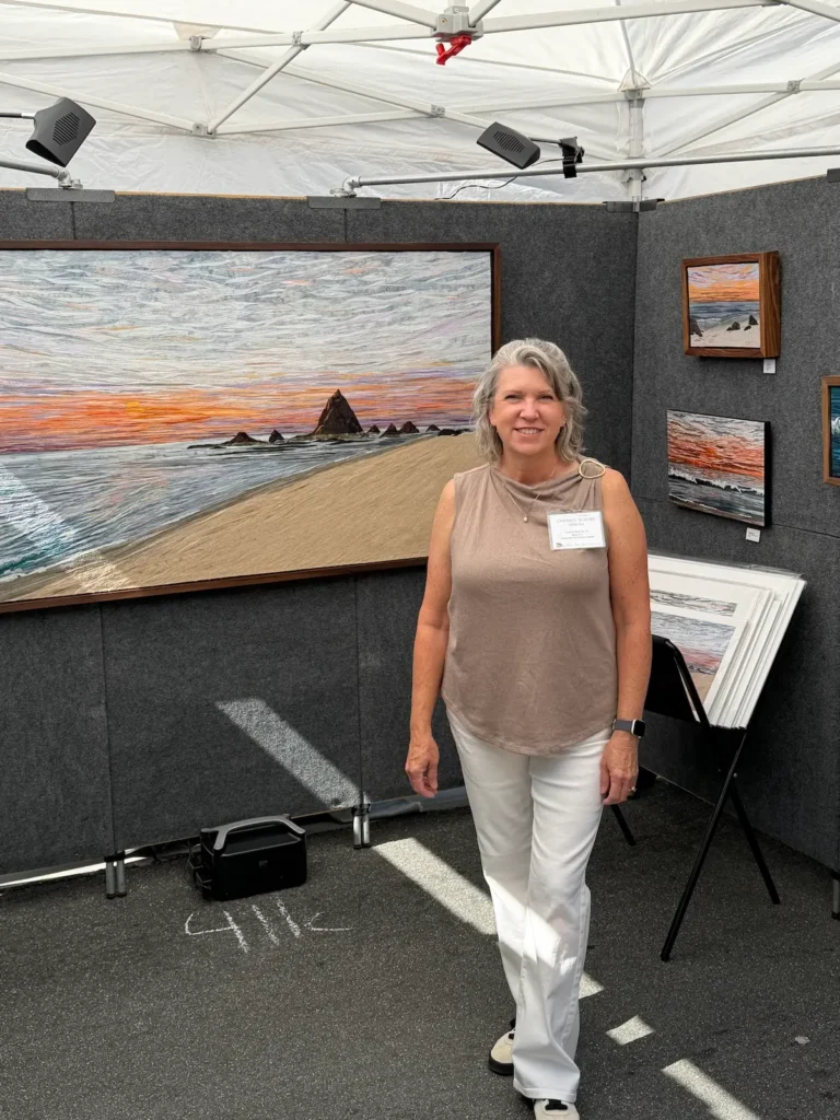 Cynthia Minoli in a booth at an art fair