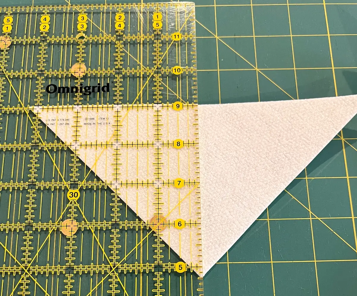 Cutting the triangles in half to form the four triangles for the sides of the fabric box top