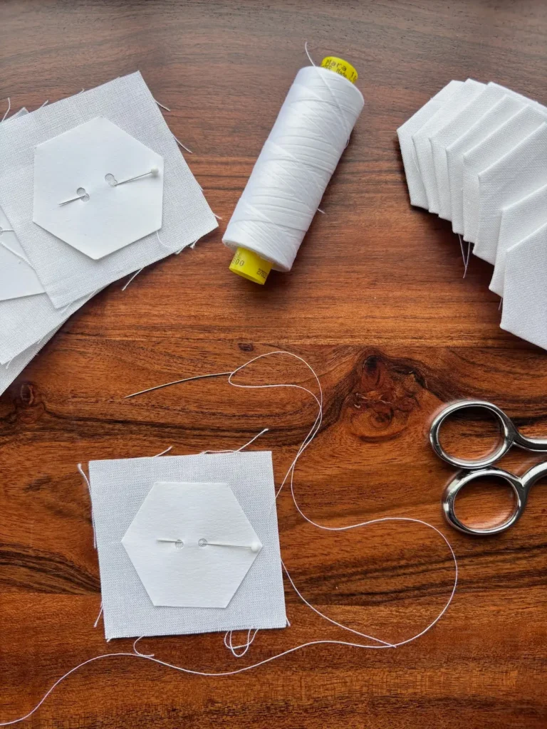 Working on white hexies for the garden quilt by Marie-Elise McNeeley