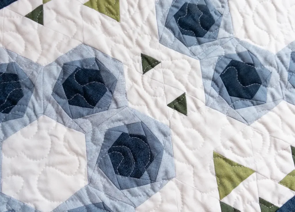 Finished quilt close-up of the Hexies in Bloom by Marie-Elise McNeeley