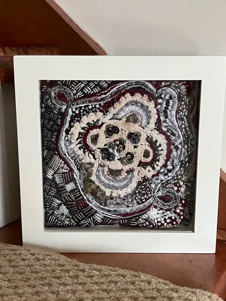 Black and white embroidered and beaded fiber art by MaryAnne Lupinetti
