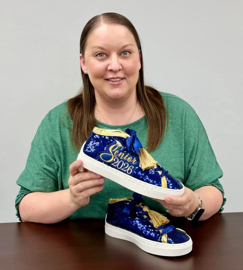 Natalie Buxkemper and pair of sneakers she made for a 2026 senior