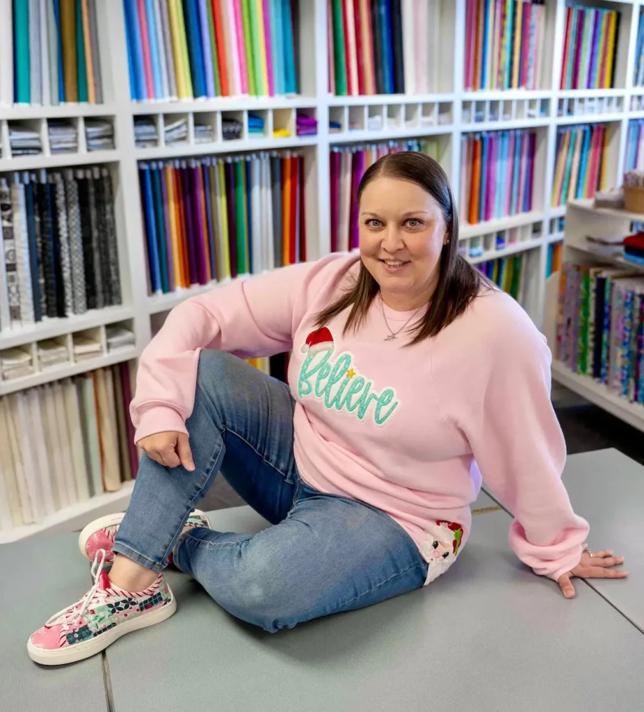 Natalie Buxkemper in her Patchwork kicks in front of a wall of fabric