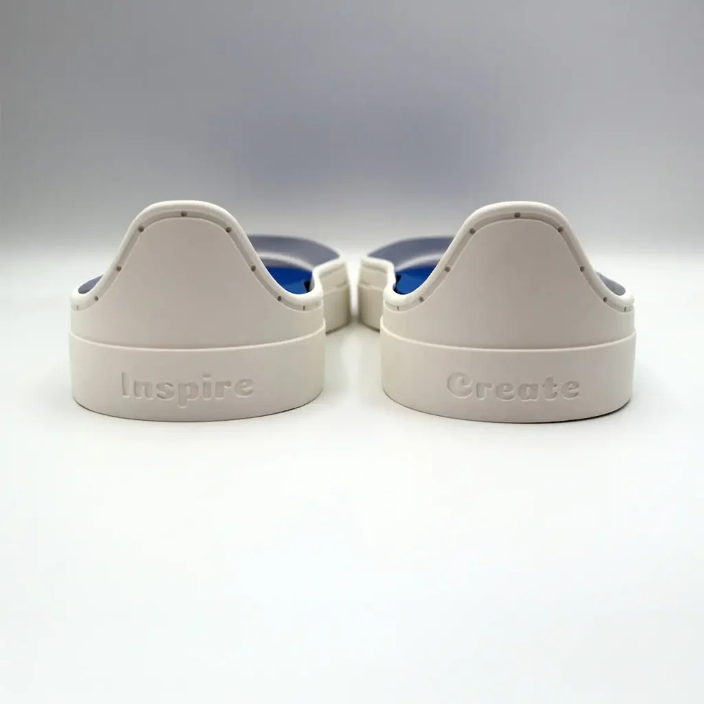 Back of shoe soles that say Inspire and Create by Natalie Buxkemper