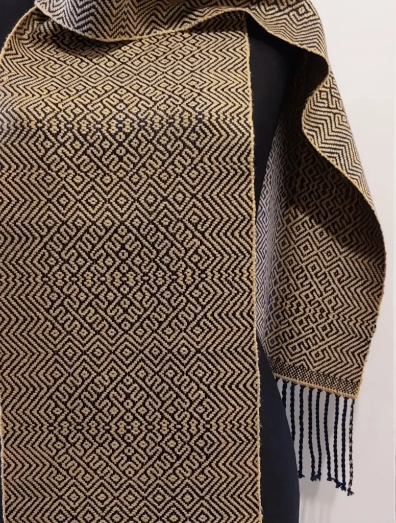 Intricate black and camel woven scarf by Vanina Bujalter
