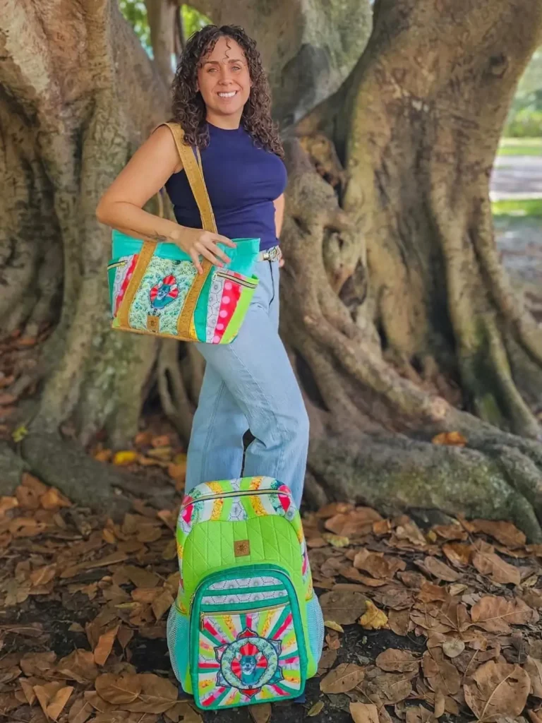 Courtney Mulvey showing off two bags she made
