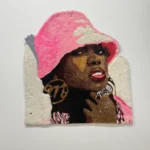 Missy woman in a pink hat rug tufted fiber art by Kid Kardiac