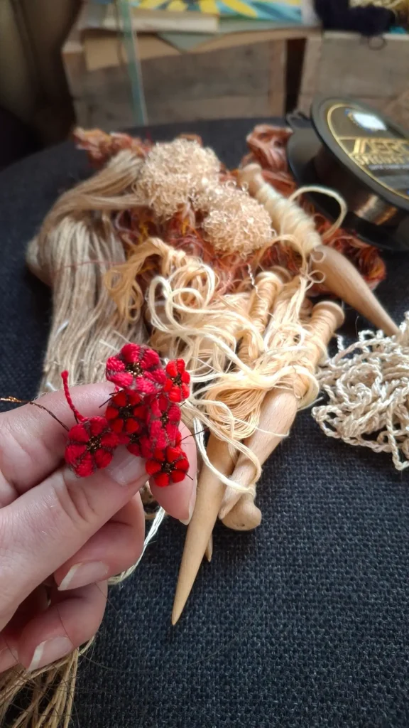 A collection of waste fibres and bobbins ready for weaving a small meadow weave by Lucy Sugden